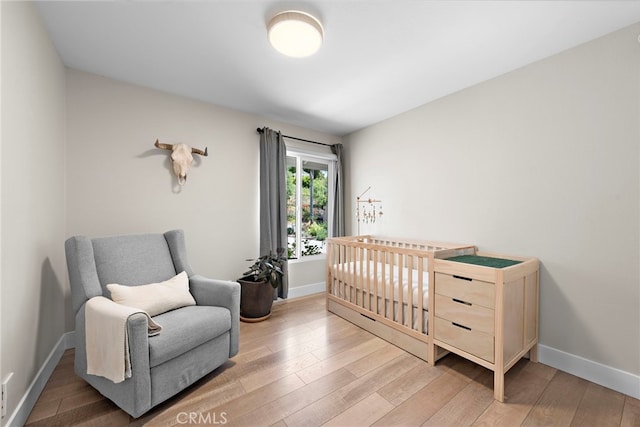 30361 Via Alcazar Ave, Laguna Niguel, CA 92677 - bedroom with light wood-style flooring and a crib