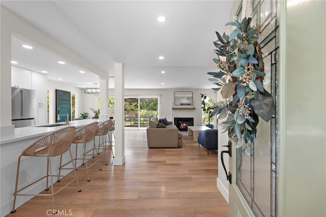 30361 Via Alcazar Ave, Laguna Niguel, CA 92677 - foyer entrance featuring recessed lighting, a lit fireplace, and light wood-style floors