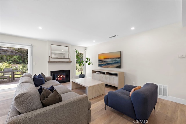 30361 Via Alcazar Ave, Laguna Niguel, CA 92677 - living area with a glass covered fireplace, light wood-style flooring, and recessed lighting