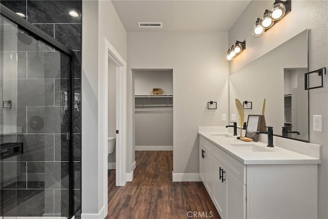 6169 Fern Ln, Paradise, CA 95969 - full bathroom with double vanity, a stall shower, and wood finished floors