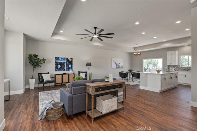 6169 Fern Ln, Paradise, CA 95969 - living room featuring a raised ceiling, dark wood-type flooring, recessed lighting, ceiling fan, and a chandelier