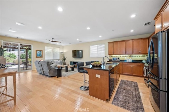 1061 Ford Dr, Nipomo, CA 93444 - kitchen featuring black appliances, a kitchen bar, plenty of natural light, open floor plan, and recessed lighting