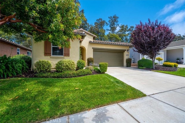 1061 Ford Dr, Nipomo, CA 93444 - view of front of home with a garage, stucco siding, concrete driveway, and a front lawn