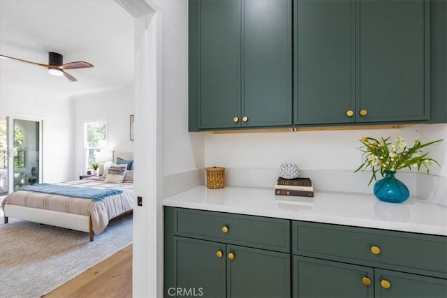 4325 9th Ave, Los Angeles, CA 90008 - kitchen featuring green cabinets, open floor plan, light countertops, and light wood-type flooring