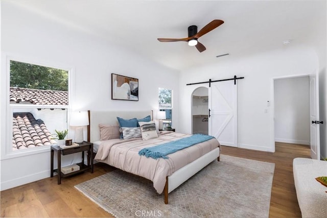 4325 9th Ave, Los Angeles, CA 90008 - bedroom with a barn door, wood finished floors, ceiling fan, and lofted ceiling