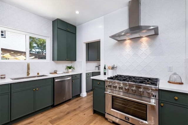 4325 9th Ave, Los Angeles, CA 90008 - kitchen featuring wall chimney range hood, stainless steel appliances, green cabinets, and recessed lighting