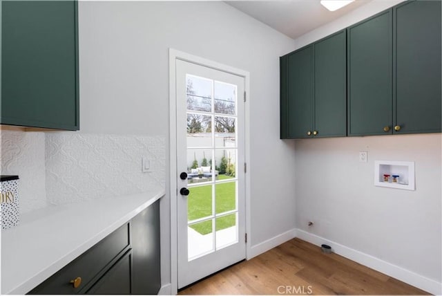 4325 9th Ave, Los Angeles, CA 90008 - laundry room with cabinet space, hookup for a washing machine, light wood-style flooring, and healthy amount of natural light