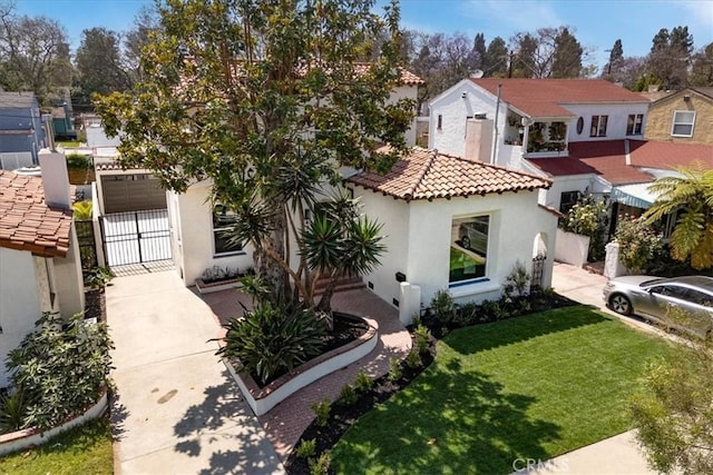4325 9th Ave, Los Angeles, CA 90008 - mediterranean / spanish home with a gate, stucco siding, a tiled roof, and driveway