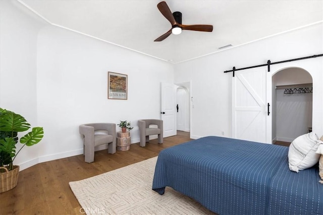 4325 9th Ave, Los Angeles, CA 90008 - bedroom with a barn door, wood finished floors, and ceiling fan