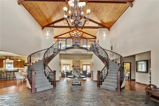 858 Fox Tower Way, Big Bear Lake, CA 92314 - foyer entrance featuring high vaulted ceiling, stairs, a chandelier, stone finish flooring, and a wooden ceiling with exposed beams
