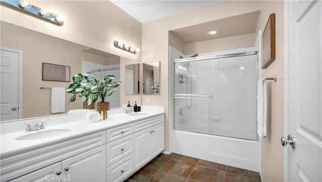 66 Full Moon, Irvine, CA 92618 - bathroom featuring double vanity, enclosed tub / shower combo, stone finish flooring, and recessed lighting