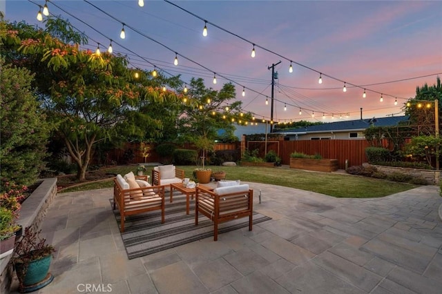 2322 246th St, Lomita, CA 90717 - patio terrace at dusk featuring a patio area, a fenced backyard, and an outdoor hangout area