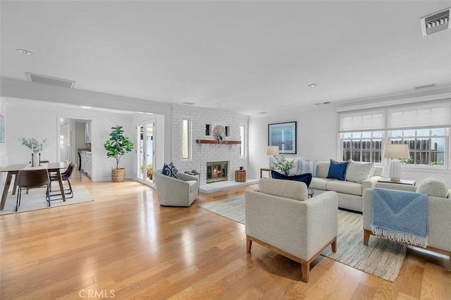 2322 246th St, Lomita, CA 90717 - living room with light wood-style flooring, a brick fireplace, and recessed lighting