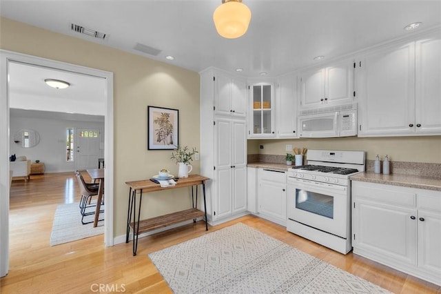2322 246th St, Lomita, CA 90717 - kitchen featuring white appliances, white cabinets, light wood-style floors, and recessed lighting