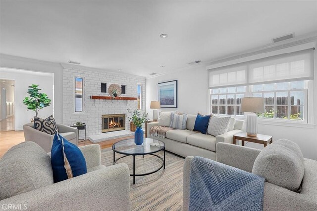 2322 246th St, Lomita, CA 90717 - living room featuring ornamental molding, a fireplace, light wood-style flooring, and recessed lighting