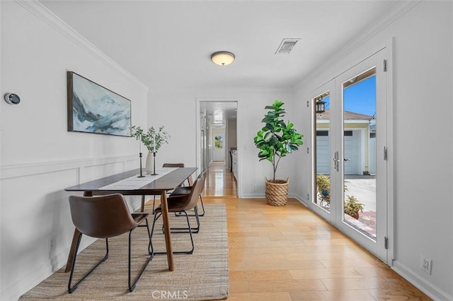 2322 246th St, Lomita, CA 90717 - dining area with light wood finished floors, ornamental molding, and french doors
