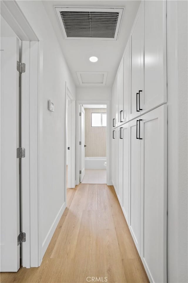 7312 Loch Alene Ave, Pico Rivera, CA 90660 - hallway featuring attic access and light wood-style flooring