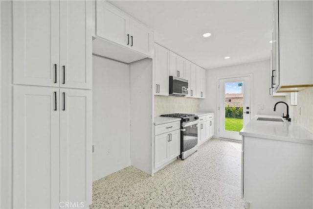 7312 Loch Alene Ave, Pico Rivera, CA 90660 - kitchen featuring stainless steel appliances, white cabinetry, light countertops, and recessed lighting