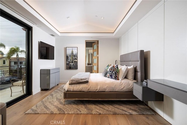 501 Ocean Ave, Seal Beach, CA 90740 - bedroom with a tray ceiling, access to exterior, and wood finished floors