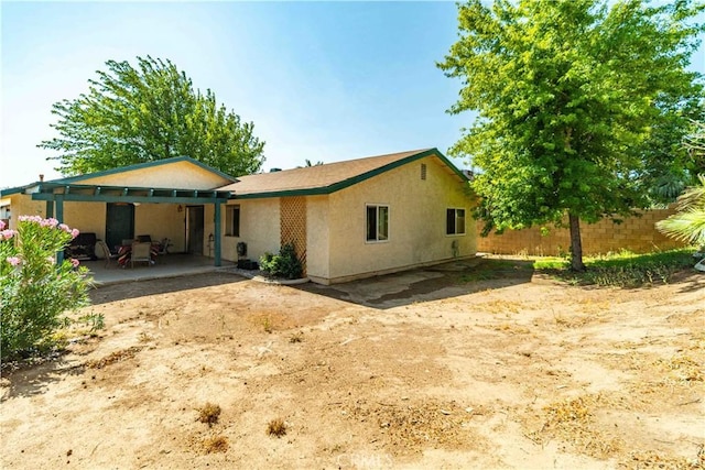 37229 Dalzell St, Palmdale, CA 93550 - rear view of property with stucco siding and a patio area