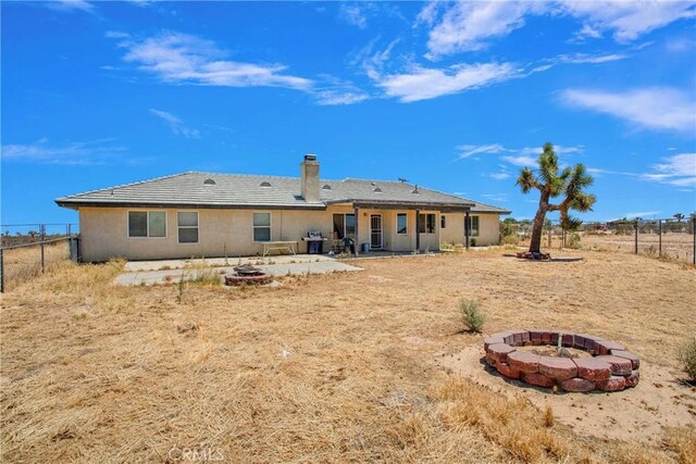 14480 Nevada Rd, Phelan, CA 92371 - back of house featuring a fire pit, a fenced backyard, a patio area, and a chimney