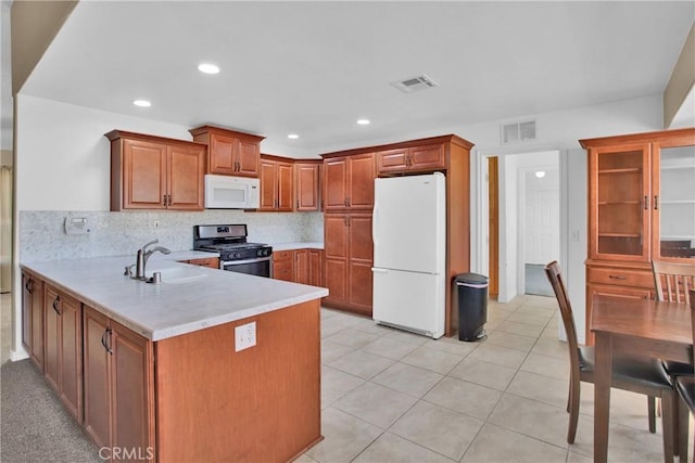 14480 Nevada Rd, Phelan, CA 92371 - kitchen with white appliances, light countertops, a peninsula, backsplash, and brown cabinetry