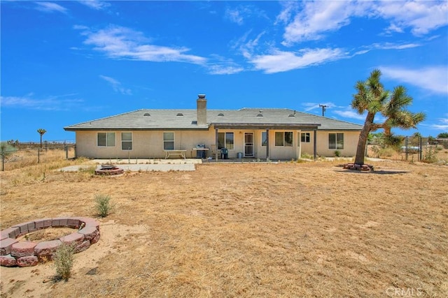 14480 Nevada Rd, Phelan, CA 92371 - back of house with a fire pit, a patio, and a chimney