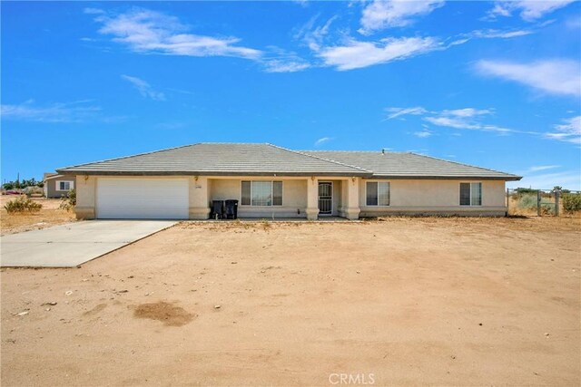 14480 Nevada Rd, Phelan, CA 92371 - view of front of property with an attached garage, concrete driveway, stucco siding, and a tile roof