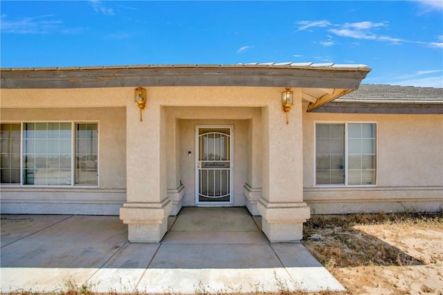 14480 Nevada Rd, Phelan, CA 92371 - property entrance with stucco siding and a patio area