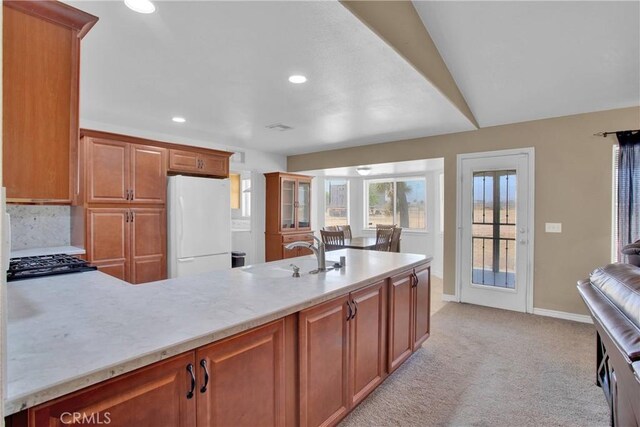 14480 Nevada Rd, Phelan, CA 92371 - kitchen with freestanding refrigerator, recessed lighting, light colored carpet, a peninsula, and cooktop
