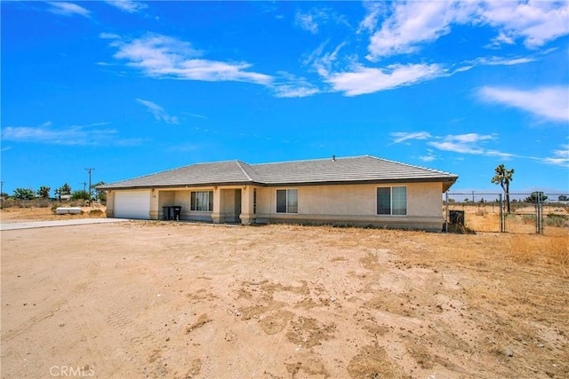 14480 Nevada Rd, Phelan, CA 92371 - view of front facade with a garage, driveway, and stucco siding