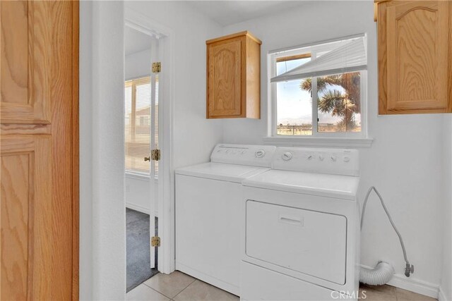 14480 Nevada Rd, Phelan, CA 92371 - laundry area with cabinet space, independent washer and dryer, and light tile patterned floors