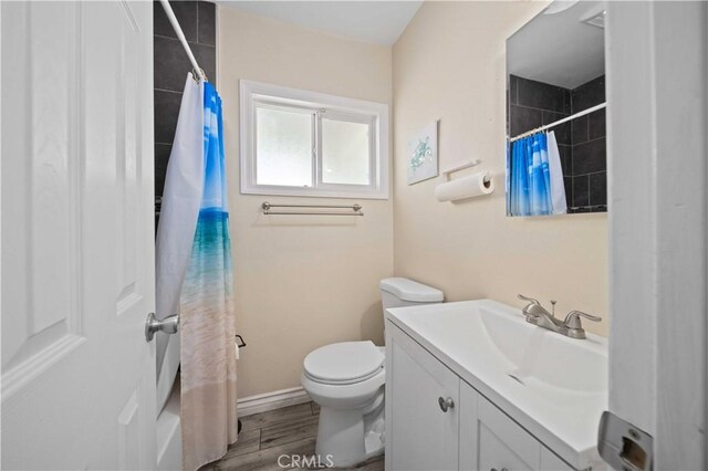 6838 Severn Dr, Paramount, CA 90723 - full bath with vanity, curtained shower, and wood finished floors