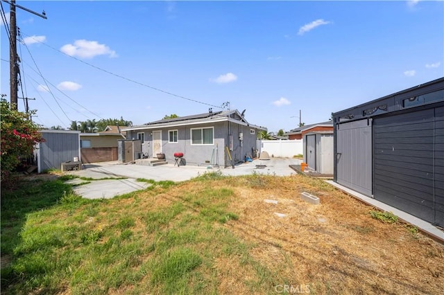 6838 Severn Dr, Paramount, CA 90723 - back of property with a shed, a patio, and solar panels