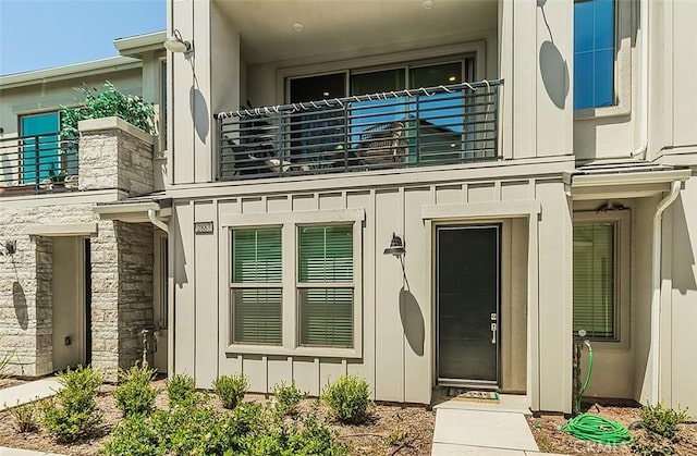 2887 E Tamarind Dr, Fresno, CA 93730 - doorway to property with a balcony and board and batten siding