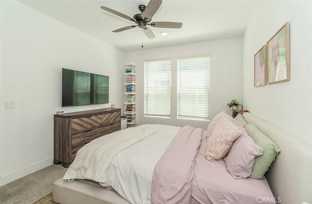 2887 E Tamarind Dr, Fresno, CA 93730 - carpeted bedroom with baseboards and ceiling fan