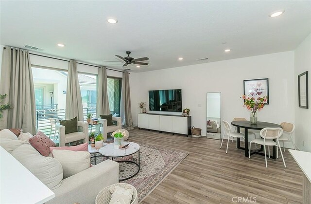 2887 E Tamarind Dr, Fresno, CA 93730 - living area featuring light wood finished floors, recessed lighting, and a ceiling fan
