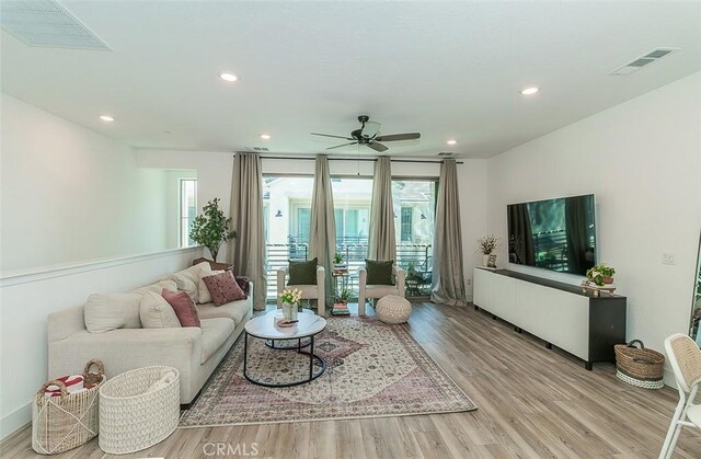 2887 E Tamarind Dr, Fresno, CA 93730 - living room featuring wood finished floors, a ceiling fan, and recessed lighting