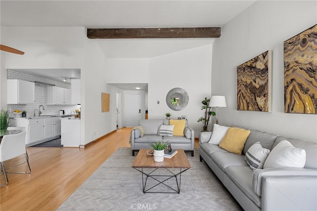 5650 Sumner Way Unit 309, Culver City, CA 90230 - living room featuring light wood finished floors and beamed ceiling