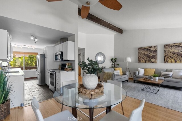 5650 Sumner Way Unit 309, Culver City, CA 90230 - dining area featuring ceiling fan, light wood-style flooring, and beamed ceiling