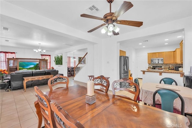 3739 Cherisa St, Perris, CA 92571 - dining room featuring a chandelier, light tile patterned flooring, stairway, ceiling fan, and recessed lighting