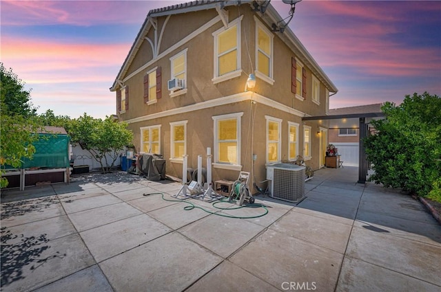 3739 Cherisa St, Perris, CA 92571 - back of house at dusk with stucco siding, a patio, and a fenced backyard