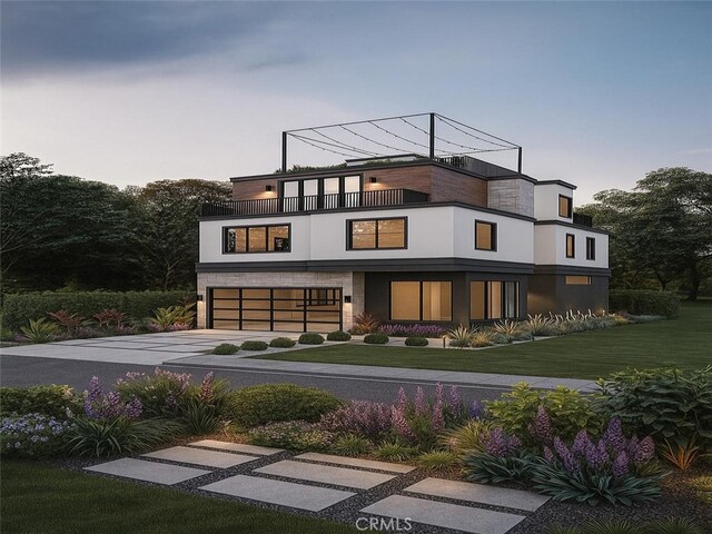 344 Portland Cir Unit 342, Huntington Beach, CA 92648 - back of house at dusk with a balcony, concrete driveway, an attached garage, stucco siding, and a yard