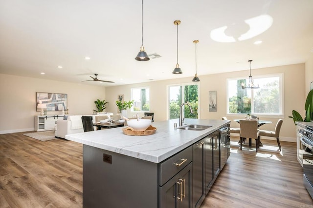 1904 Grey Rabbit Hollow Ln, Fallbrook, CA 92028 - kitchen with recessed lighting, ceiling fan, a kitchen island with sink, pendant lighting, and light stone countertops