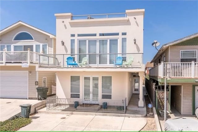 325 Juanita Ave, Oceano, CA 93445 - rear view of property featuring stucco siding, a balcony, french doors, and an attached garage