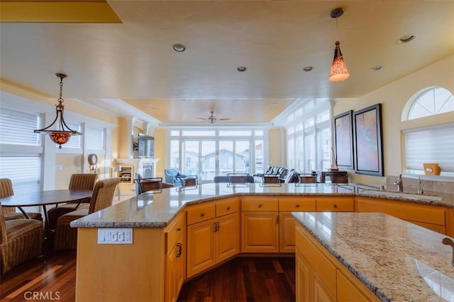 325 Juanita Ave, Oceano, CA 93445 - kitchen with dark wood-type flooring, light stone countertops, decorative light fixtures, and recessed lighting
