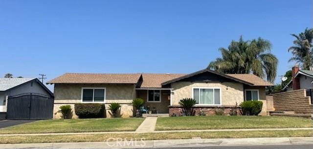 7430 Leucite Ave, Rancho Cucamonga, CA 91730 - ranch-style home with stucco siding and a front yard