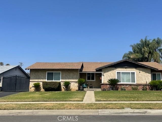 7430 Leucite Ave, Rancho Cucamonga, CA 91730 - single story home featuring stucco siding, a front yard, and an outdoor structure