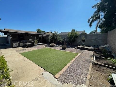 7430 Leucite Ave, Rancho Cucamonga, CA 91730 - fenced backyard with a patio area and a vegetable garden