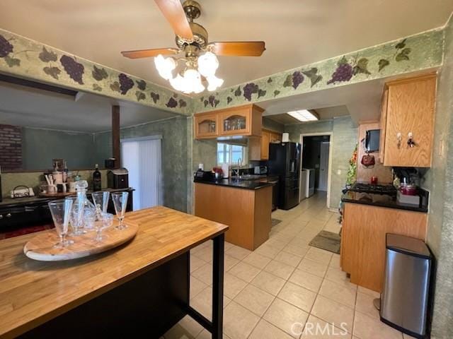 7430 Leucite Ave, Rancho Cucamonga, CA 91730 - kitchen featuring freestanding refrigerator, light tile patterned floors, ceiling fan, glass insert cabinets, and dark countertops